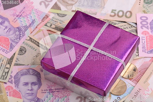 Image of american money and red gift box, european money