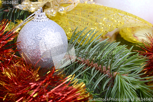 Image of Closeup of Christmas balls and green fir tree branch, new year invitation card