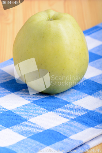 Image of Fresh green apple on blue material backgound
