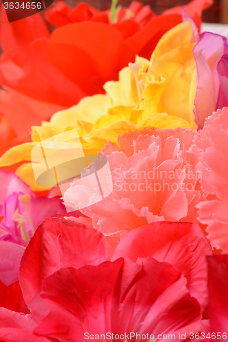 Image of artificial flowers red handmade velor tissue background close up