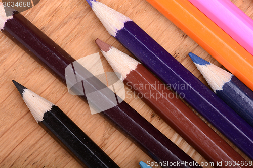 Image of Frame of old Colour pencils on Old wooden plate texture background