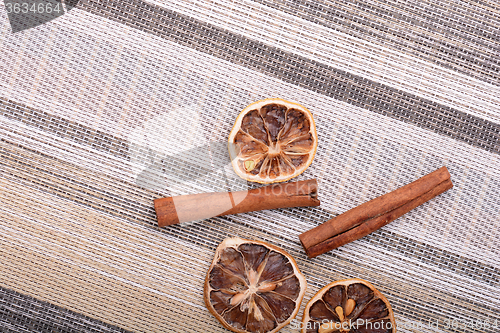 Image of Slices of fresh dried lemon, orange and spices for cooking or baking