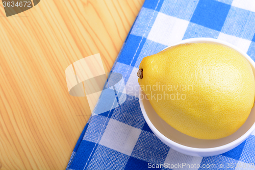 Image of ripe lemons on a white plate