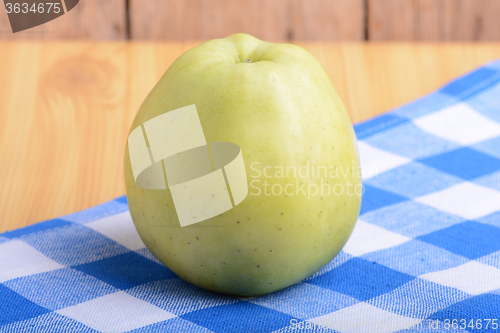 Image of Fresh green apple on blue material backgound