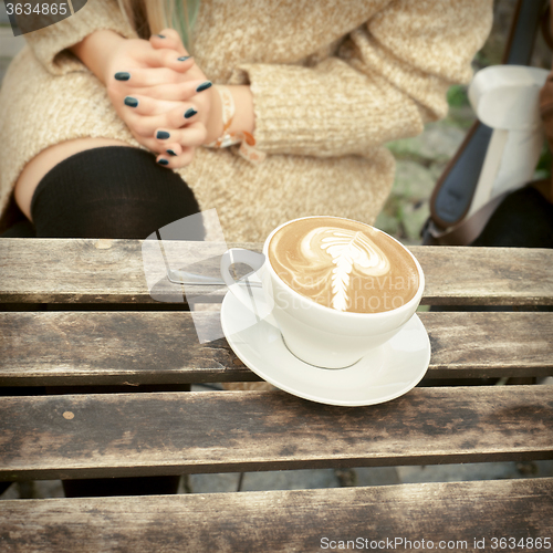 Image of cup of coffee latte on a wooden table