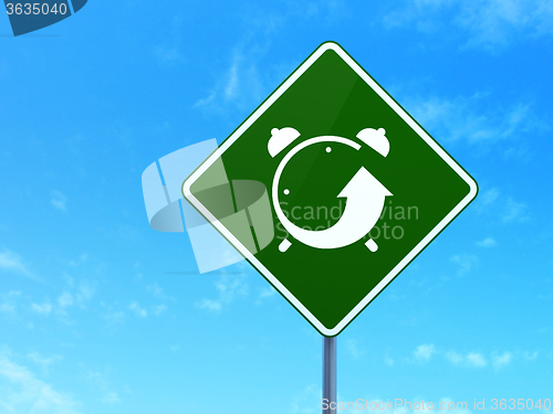 Image of Timeline concept: Alarm Clock on road sign background