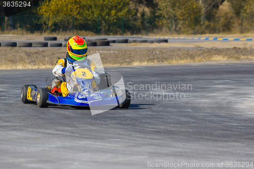 Image of Karting - driver in helmet on kart circuit