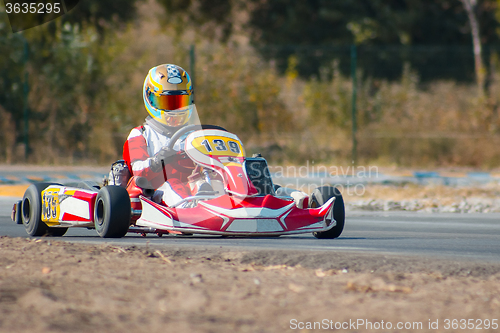 Image of Karting - driver in helmet on kart circuit