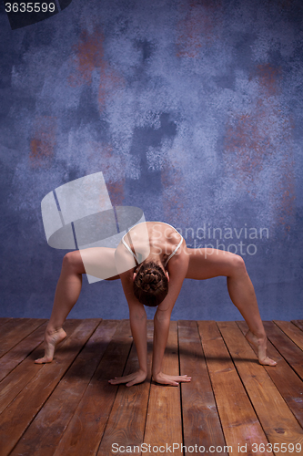 Image of Young beautiful dancer in beige swimwear dancing on lilac background