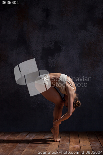 Image of Young beautiful dancer in beige swimwear dancing on lilac background