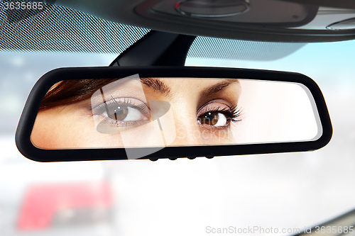 Image of driver looks to rear-view mirror