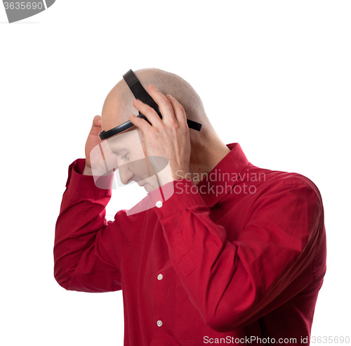 Image of Young man puts on head headset EEG (electroencephalography)