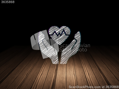 Image of Insurance concept: Heart And Palm in grunge dark room