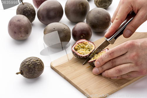 Image of Knife Cutting A Passion Fruit Into Halves