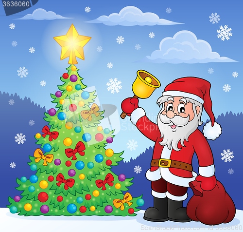 Image of Santa Claus with bell by Christmas tree