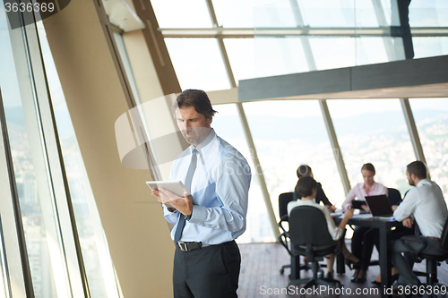 Image of handosme business man working on tablet