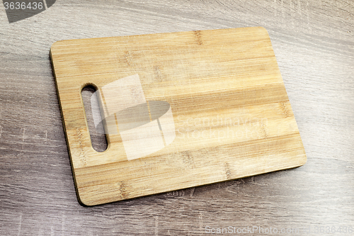 Image of old wooden cutting board on the table