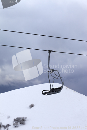 Image of Chair lift at gray evening
