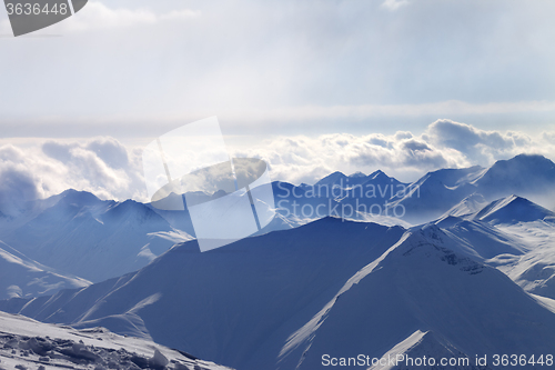 Image of Silhouette of evening sunlight mountains in mist