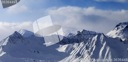 Image of Panoramic view on snowy mountains in clouds