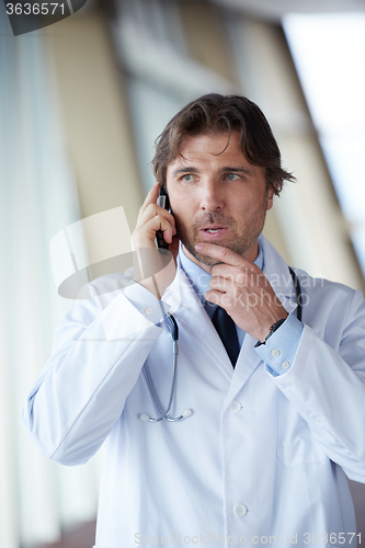 Image of doctor speaking on cellphone