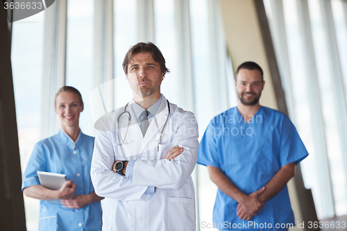 Image of group of medical staff at hospital, handsome doctor in front of 