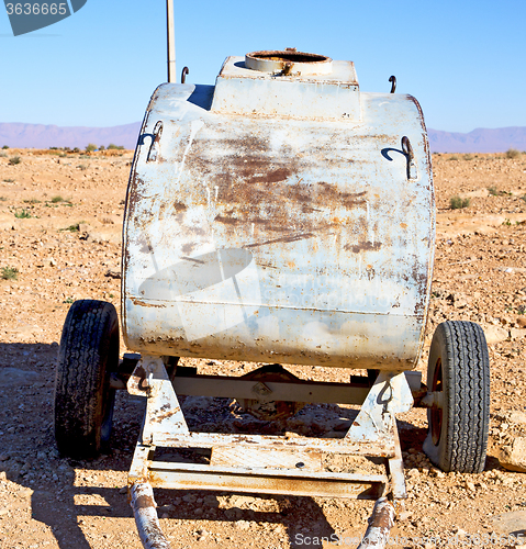 Image of water tank in morocco africa land gray  metal weel and arid