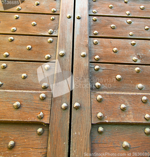 Image of  cross lombardy   arsago blur rusty brass brown knocker in a  do