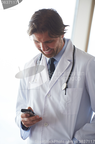 Image of doctor speaking on cellphone