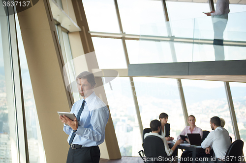 Image of handosme business man working on tablet