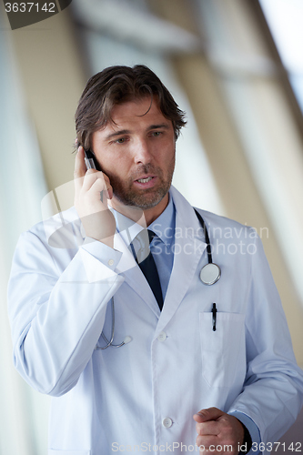 Image of doctor speaking on cellphone