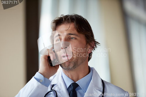 Image of doctor speaking on cellphone