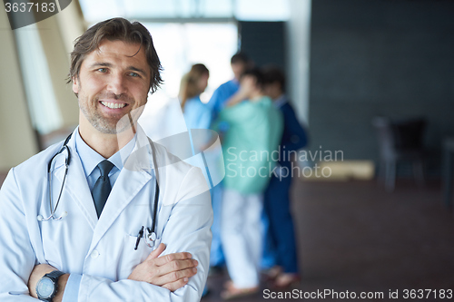 Image of group of medical staff at hospital, handsome doctor in front of 