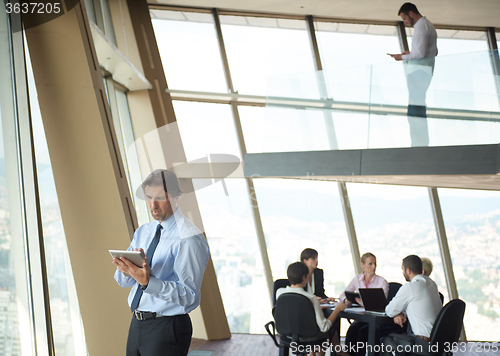 Image of handosme business man working on tablet