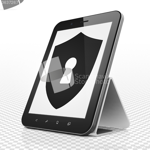 Image of Protection concept: Tablet Computer with Shield With Keyhole on display