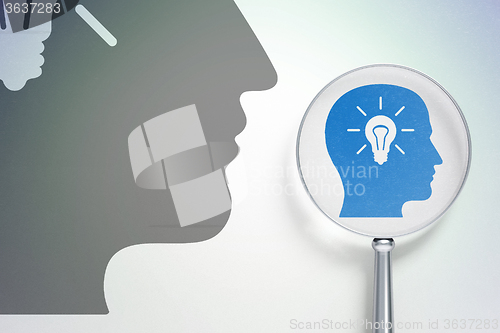 Image of Business concept:  Head With Light Bulb with optical glass on digital background