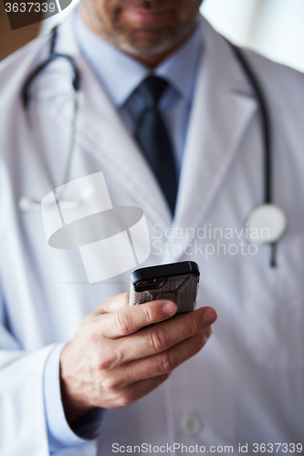 Image of doctor speaking on cellphone