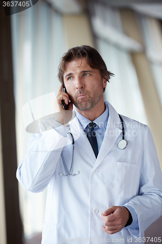 Image of doctor speaking on cellphone