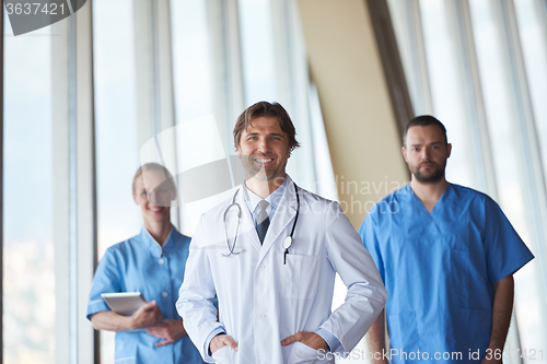 Image of group of medical staff at hospital, handsome doctor in front of 