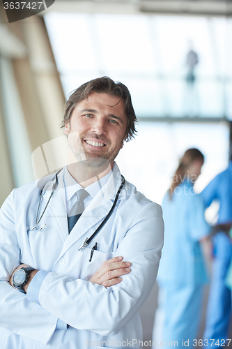 Image of group of medical staff at hospital, handsome doctor in front of 