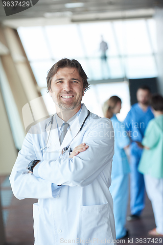 Image of group of medical staff at hospital, handsome doctor in front of 