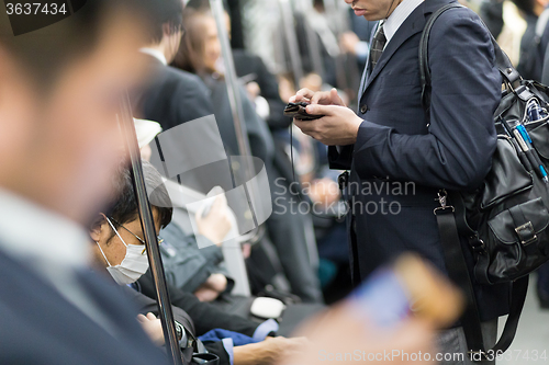 Image of Business people traveling by Tokyo metro.