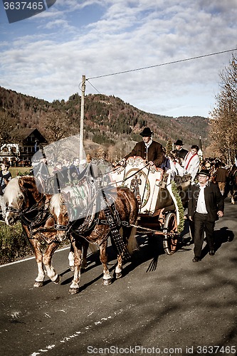 Image of Schliersee, Germany, Bavaria,  November 08, 2015: horse-drawn carriage with altar boys in Schliersee in Leonhardifahrt