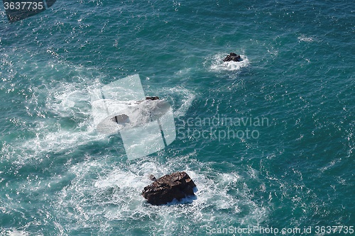 Image of Waves breaking on rocks in sea