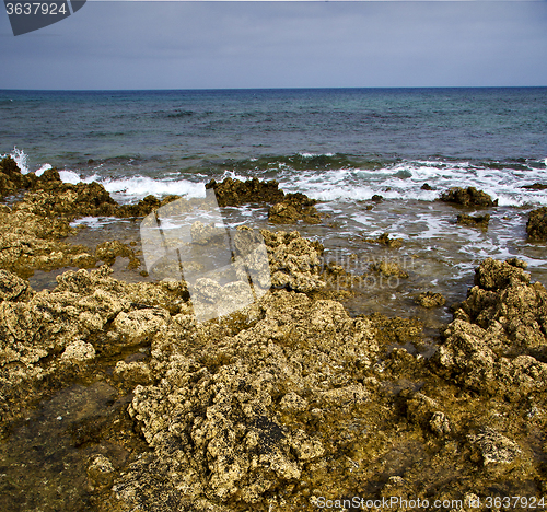 Image of  water  in lanzarote  isle foam  stone sky cloud beach  