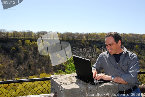 Image of Smiling man working outdoors