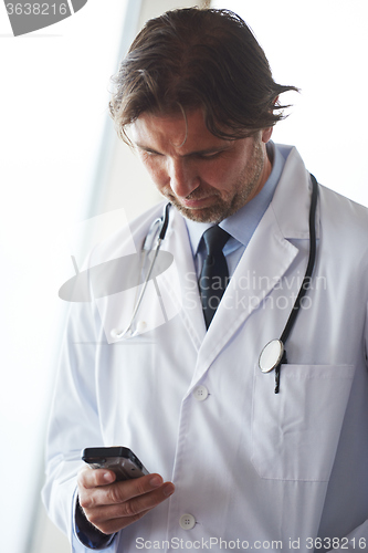 Image of doctor speaking on cellphone
