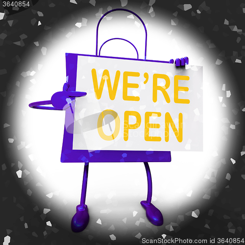 Image of We\'re Open Sign on Shopping Bag Shows New Store Launch Or Openin