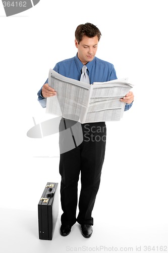 Image of Businessman reading newspaper