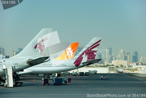 Image of Qatar airplane tails and city skyline